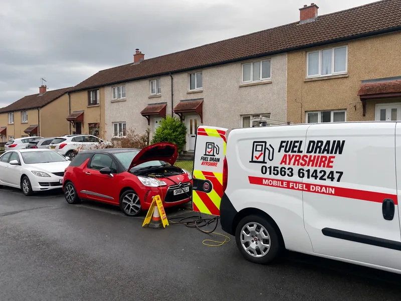 Fuel Drain Ayrshire van beside a red car with its bonnet open — AI-edited livery concept