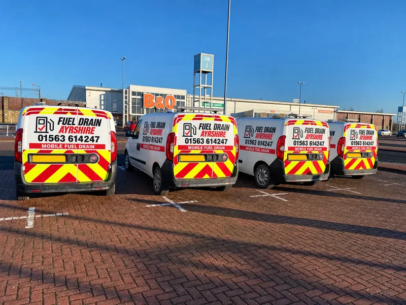 Four Fuel Drain Ayrshire vans with red and black branding — AI-edited livery concept