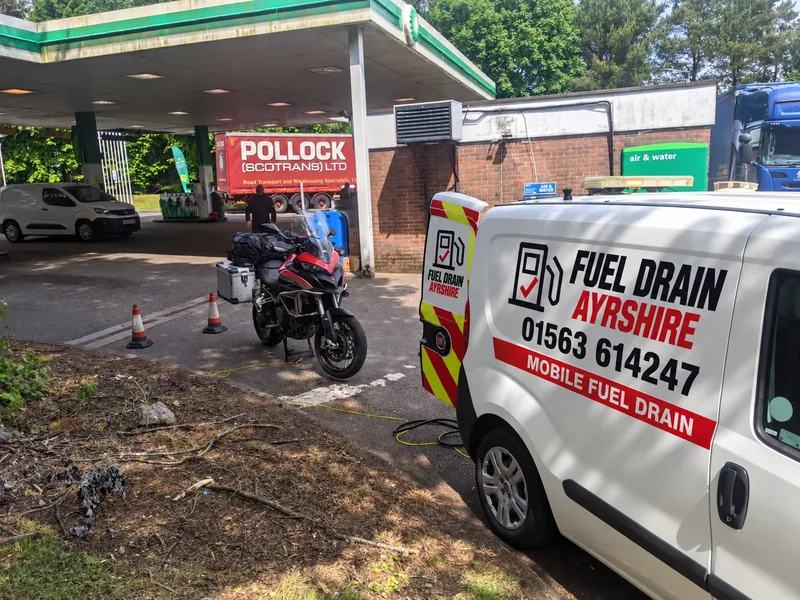 Fuel Drain Ayrshire van and motorcycle at a filling station — AI-edited livery concept